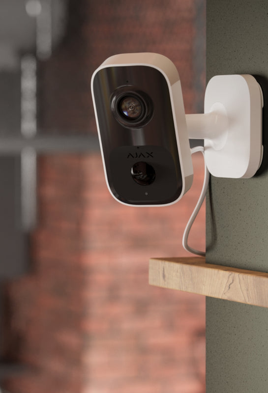 Ajax security camera mounted on a wall.